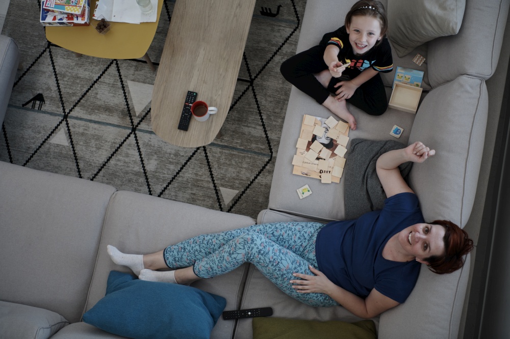 mother and daughter at home playing memory game top view