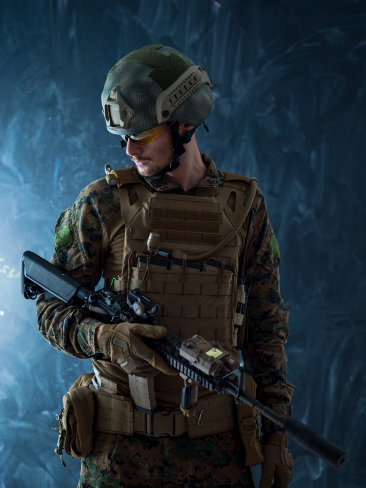 modern warfare authentic american marines soldier in protective combat gear and rifle with laser beam sight