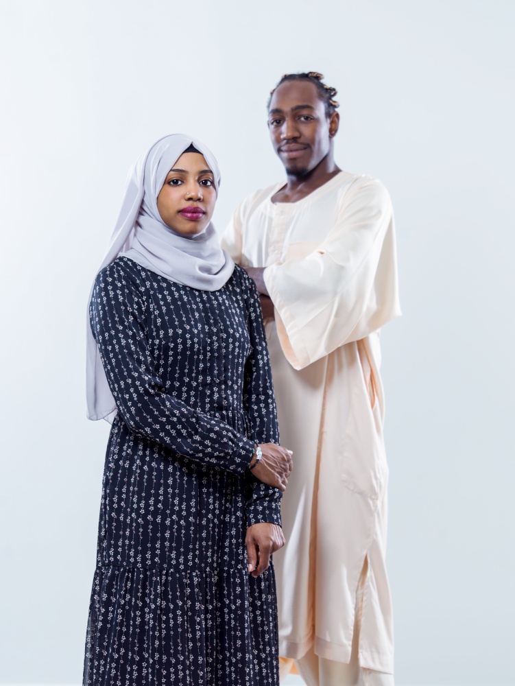 portrait of young african modern muslim couple wearing traditional clothes isolated on white background
