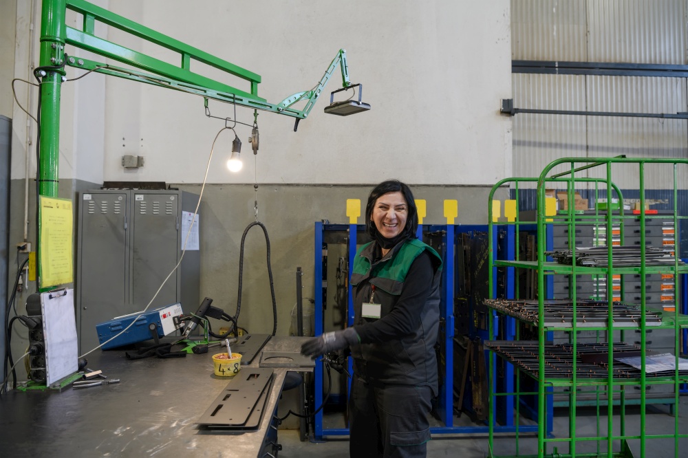 a woman working in the modern metal production and processing industry welding the product and prepares it for a CNC machine. High quality photo. a woman working in the modern metal production and processing industry welding the product and prepares it for a cnc machine