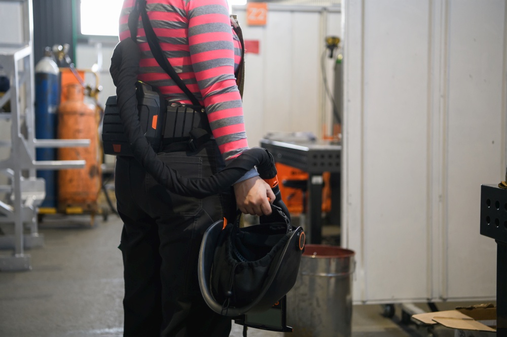 a portrait of a women welder holding a helmet and preparing for a working day in the metal industry. High quality photo. a portrait of a women welder holding a helmet and preparing for a working day in the metal industry