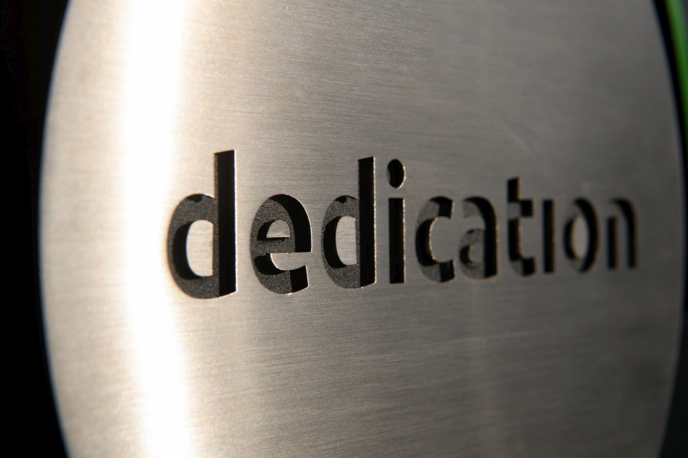 engraving a CNC machine on a piece of metal. Engraving dedication text. High quality photo. engraving a cnc machine on a piece of metal. Engraving dedication text