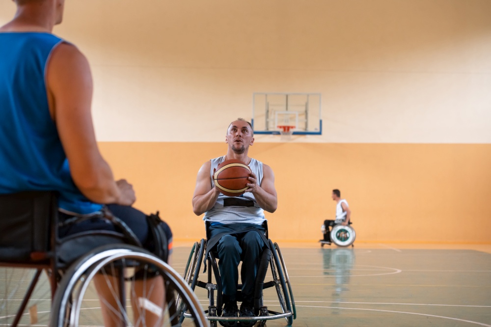 handicapped war veterans in wheelchairs with professional equipment play basketball matches in the hall. the concept of sports with disabilities. High quality photo. handicapped war veterans in wheelchairs with professional equipment play basketball match in the hall.the concept of sports with disabilities