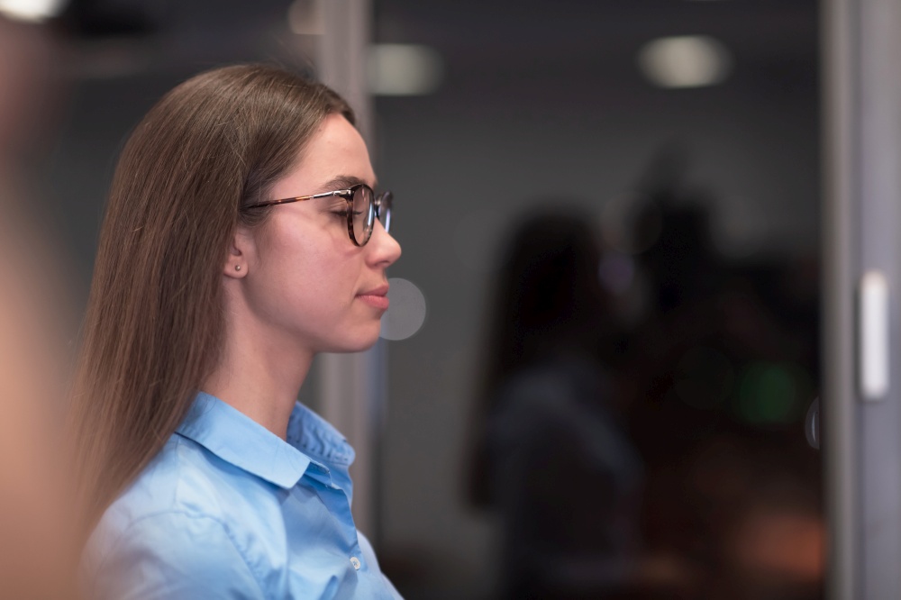 Portrait of freelancer standing in co-working space. Confident businesswoman looking at camera. High-quality photo. Portrait of freelancer standing in co-working space. Confident businesswoman looking at camera.