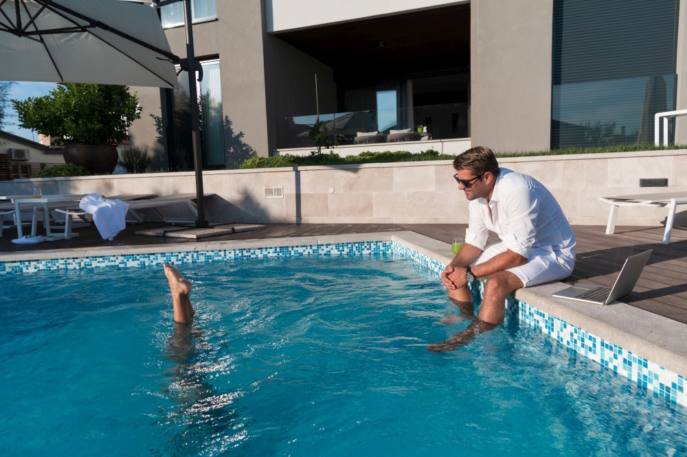 The happy family enjoys a vacation in a luxury house with a pool. Father spends time with son having fun in the pool. Selective focus. High-quality photo. Happy family enjoys vacation in luxury house with pool. Father spends time with son having fun in pool. Selective focus