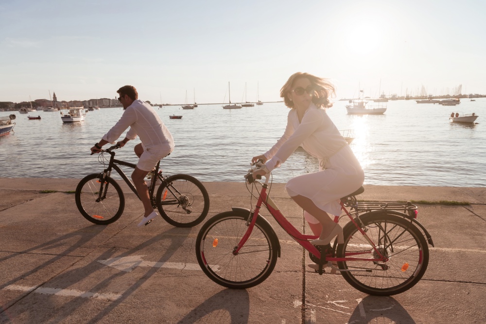 Senior couple enjoying a beautiful morning together riding a bike by the sea. Selective focus. High-quality photo. Senior couple enjoying a beautiful morning together riding a bike by the sea. Selective focus