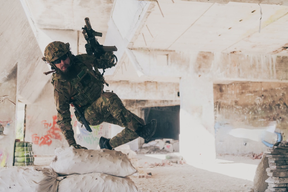 A bearded soldier in the uniform of special forces in dangerous military action in a dangerous enemy area. Selective focus. High-quality photo. A bearded soldier in uniform of special forces in a dangerous military action in a dangerous enemy area. Selective focus