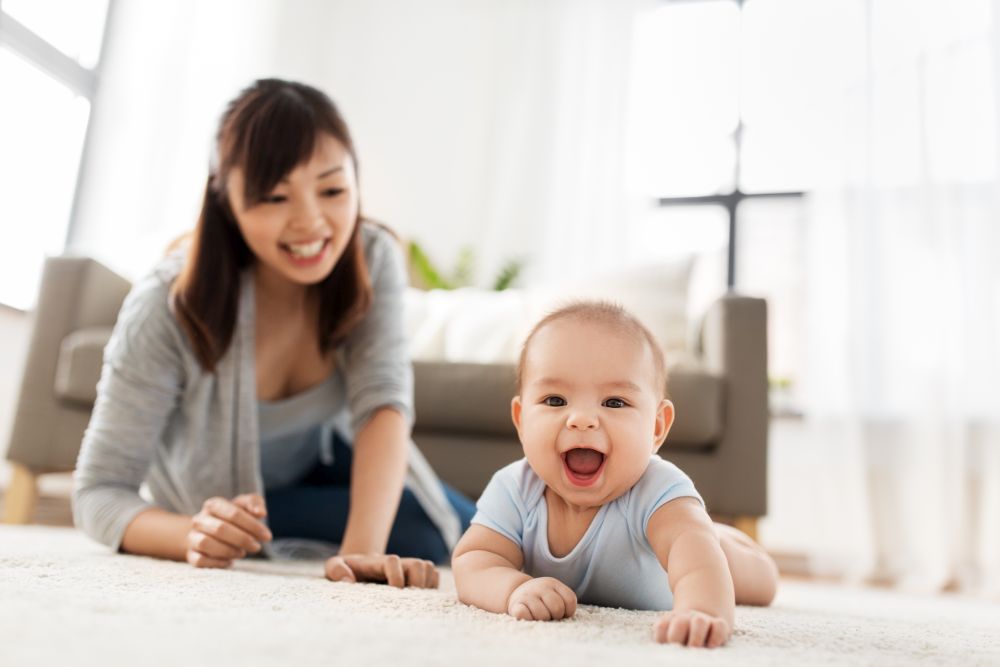 babyhood, childhood and people concept - happy little asian baby boy and mother at home. happy little asian baby boy with mother at home