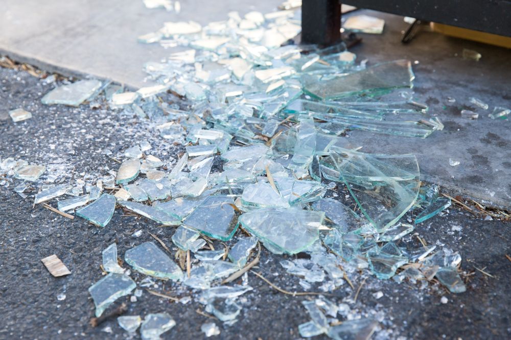 damage concept - shards of broken glass on floor. shards of broken glass on floor