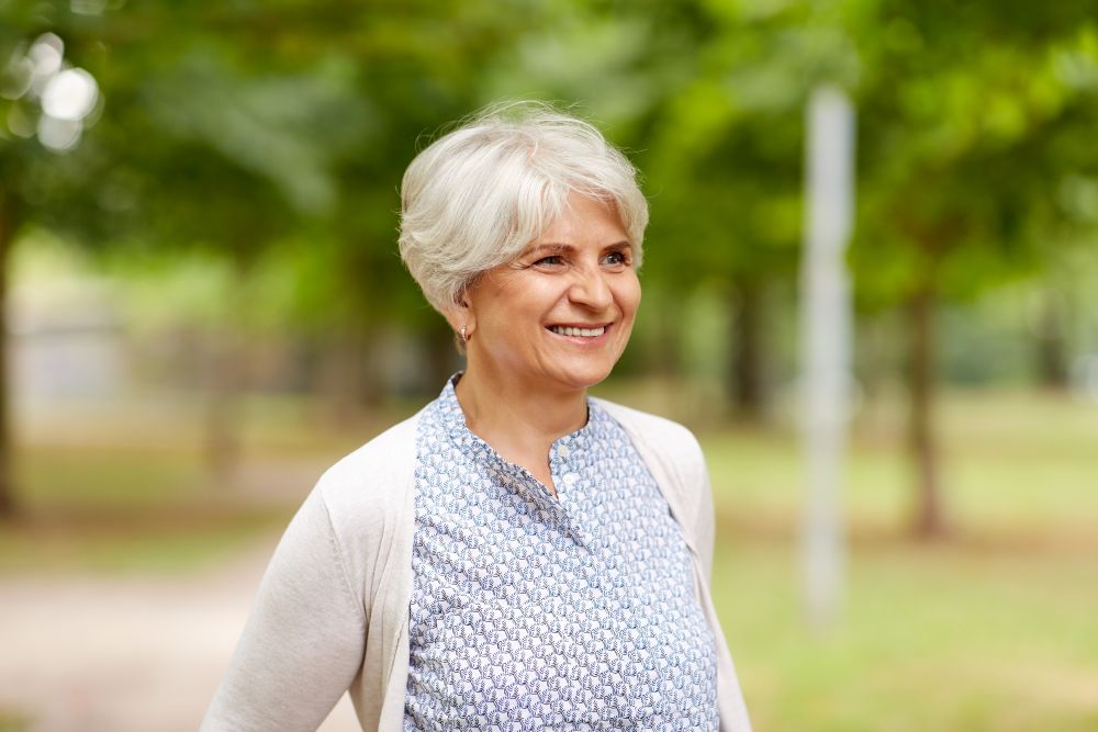 old age, retirement and people concept - portrait of happy senior woman at summer park. portrait of happy senior woman at summer park