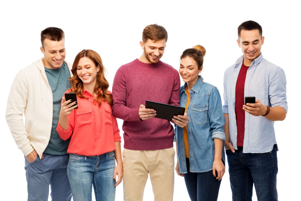 friendship and people concept - group of smiling friends with smartphones and tablet computer over white background. friends with smartphones and tablet computer