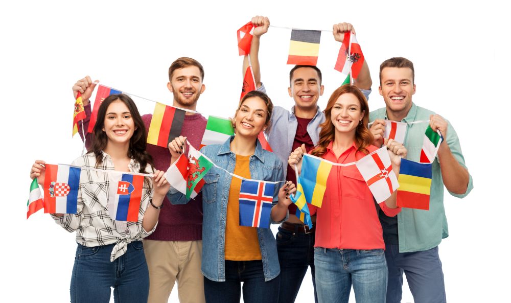 international friendship and people concept - group of smiling friends with flags of different countries string over white background. happy friends with flags of different countries