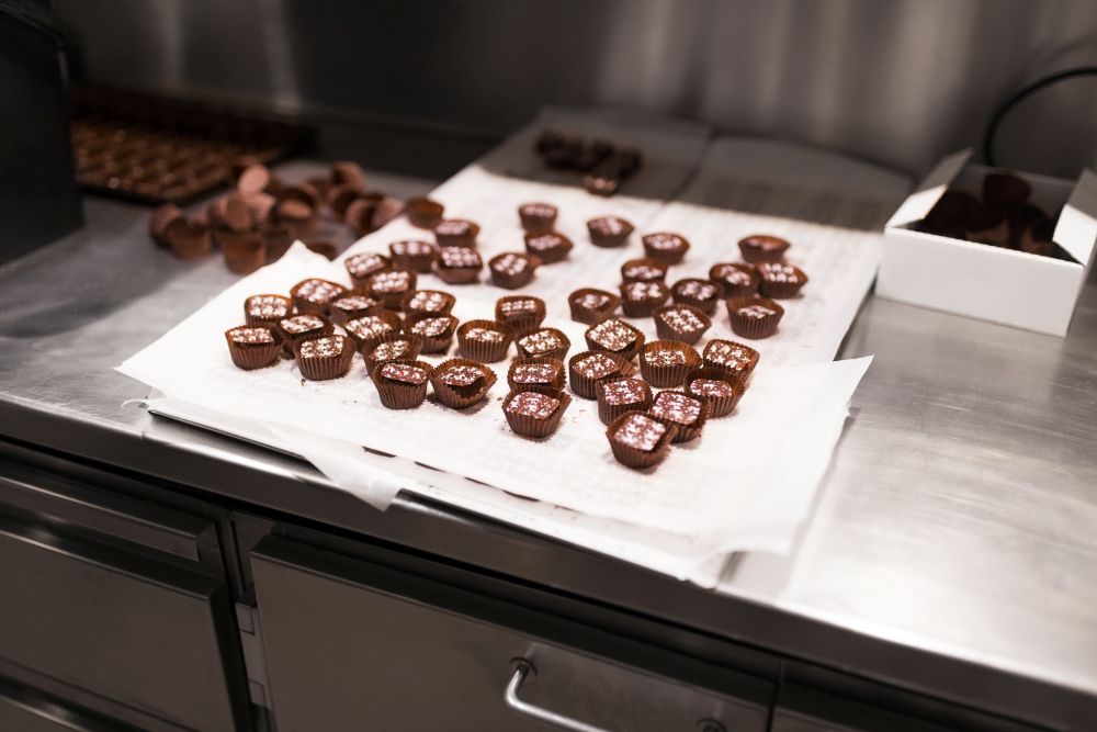 sweets production and industry concept - chocolate candies at confectionery shop. chocolate candies at confectionery shop