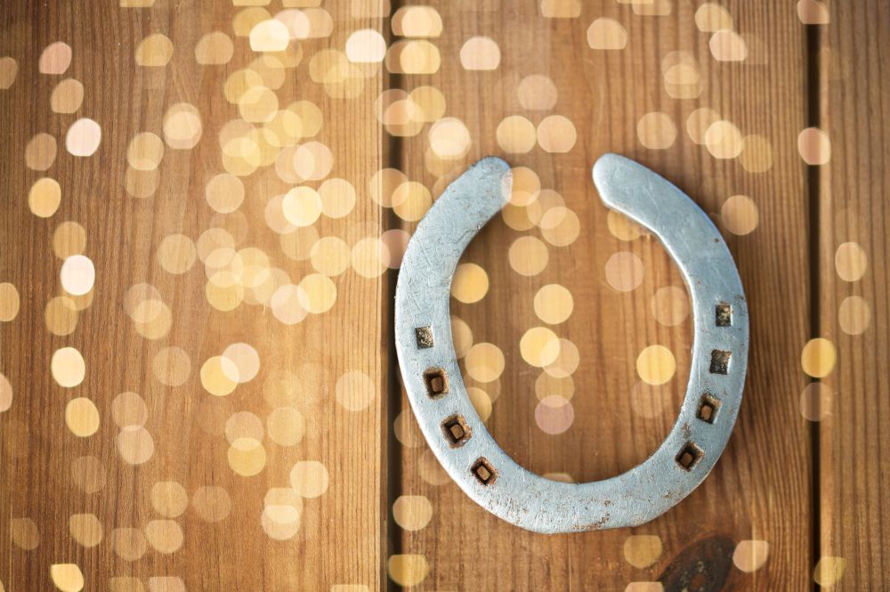 fortune and good luck concept - old horseshoe on wooden background. old horseshoe on wooden background