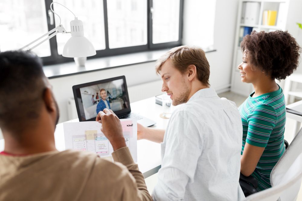 business, online communication and technology concept - happy creative team having video conference at office. creative team having video conference at office