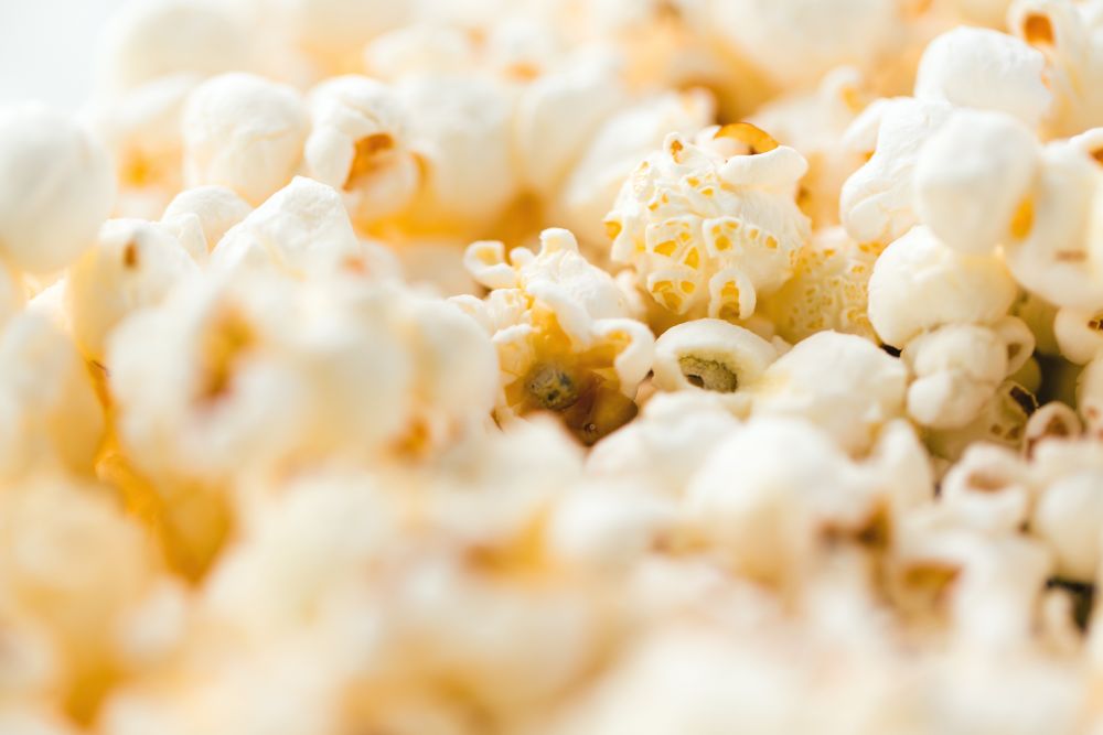 fast food, junk-food and unhealthy eating concept - close up of popcorn. close up of popcorn
