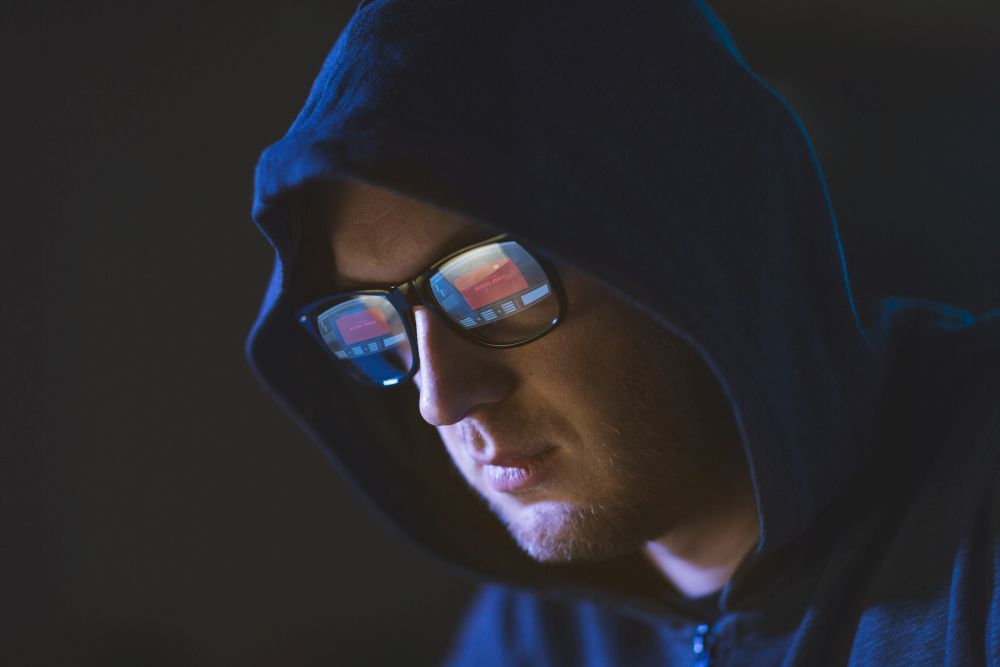 cybercrime, hacking and people concept - close up of hacker with access denied message reflecting in glasses. hacker with access denied reflecting in glasses