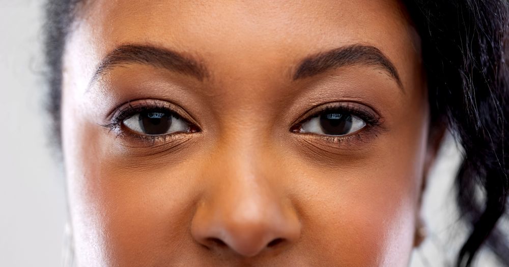 vision, make up and people concept - close up of african american woman face. close up of african american woman face