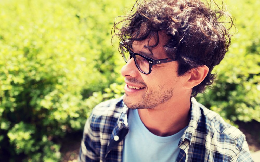 lifestyle, emotion, expression and people concept - close up of happy smiling man in eyeglasses outdoors. close up of smiling man in eyeglasses outdoors