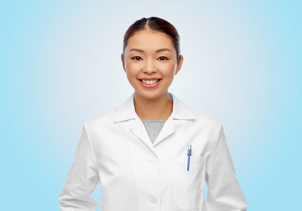 medicine, profession and healthcare concept - happy smiling asian female doctor or scientist in white coat over blue background. happy smiling asian female doctor in white coat