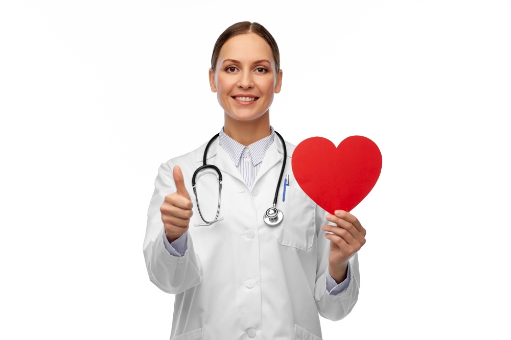 medicine, healthcare and cardiology concept - smiling female doctor with red heart and stethoscope showing thumbs up. smiling female doctor with heart showing thumbs up