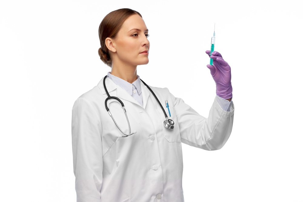 medicine, vaccination and healthcare concept - female doctor with stethoscope and syringe over white background. female doctor with medicine in syringe