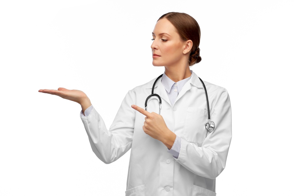 medicine, profession and healthcare concept - female doctor in white coat with stethoscope holding something invisible on her hand. female doctor holding something on her hand
