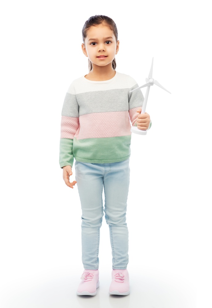 sustainable energy, power and people concept - happy smiling girl with toy wind turbine over white background. smiling girl with toy wind turbine