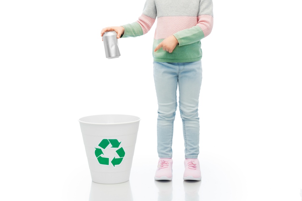 metal recycling, waste sorting and sustainability concept - girl throwing tin can into rubbish bin over white background. girl throwing tin can into rubbish bin