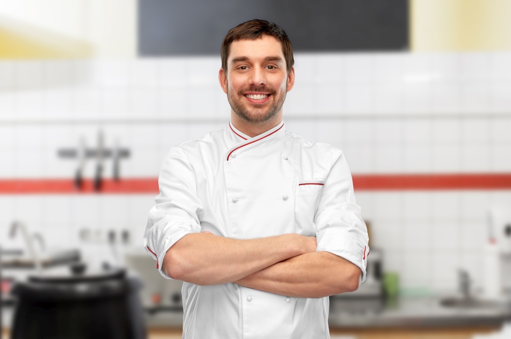 cooking, culinary and people concept - happy smiling male chef in jacket with crossed arms over grey background. happy smiling male chef with crossed arms