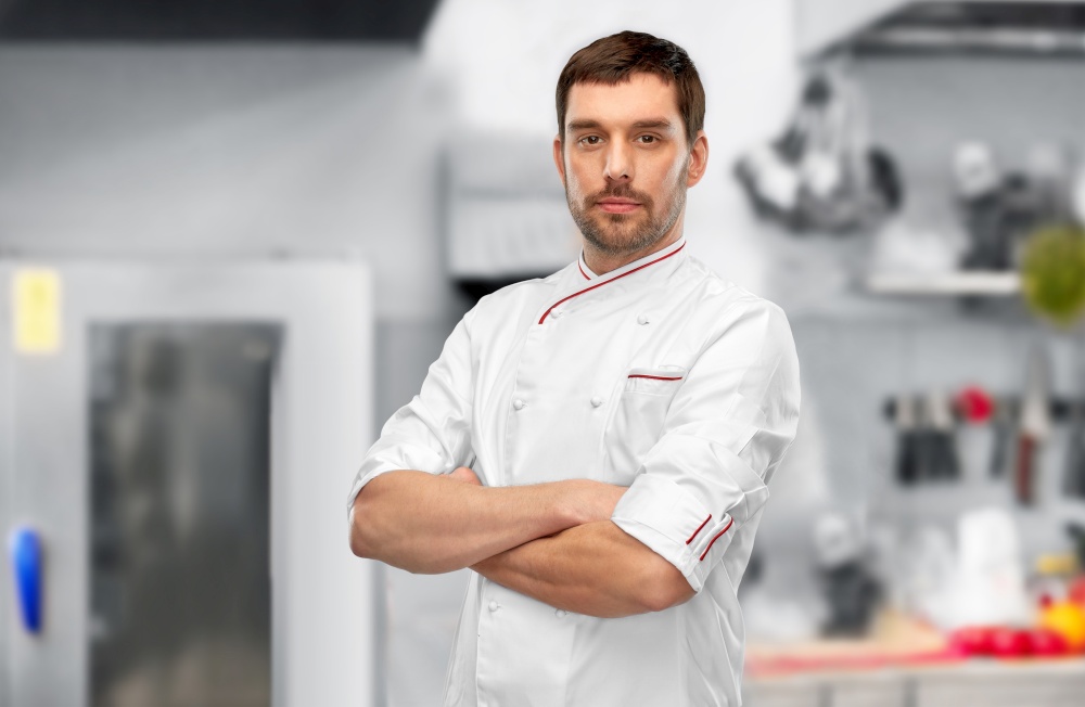 cooking, culinary and people concept - male chef in jacket with crossed arms over grey background. happy smiling male chef with crossed arms