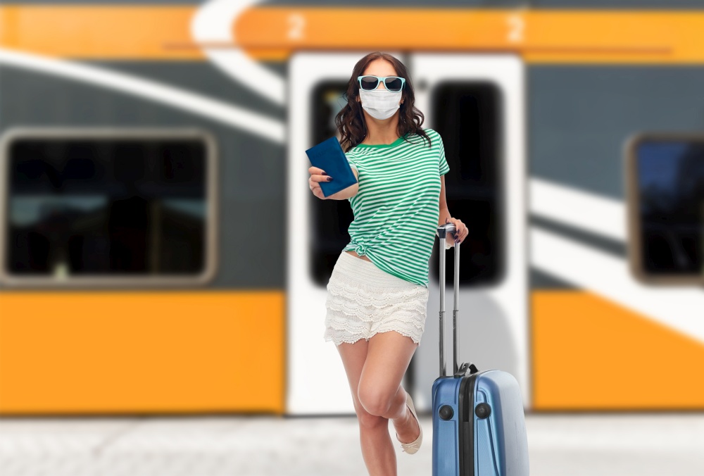 tourism, vacation and health care concept - teenage girl or young woman in mask for protection from virus and sunglasses with travel bag and passport over train on railway station on background. teenage girl in mask with travel bag and passport