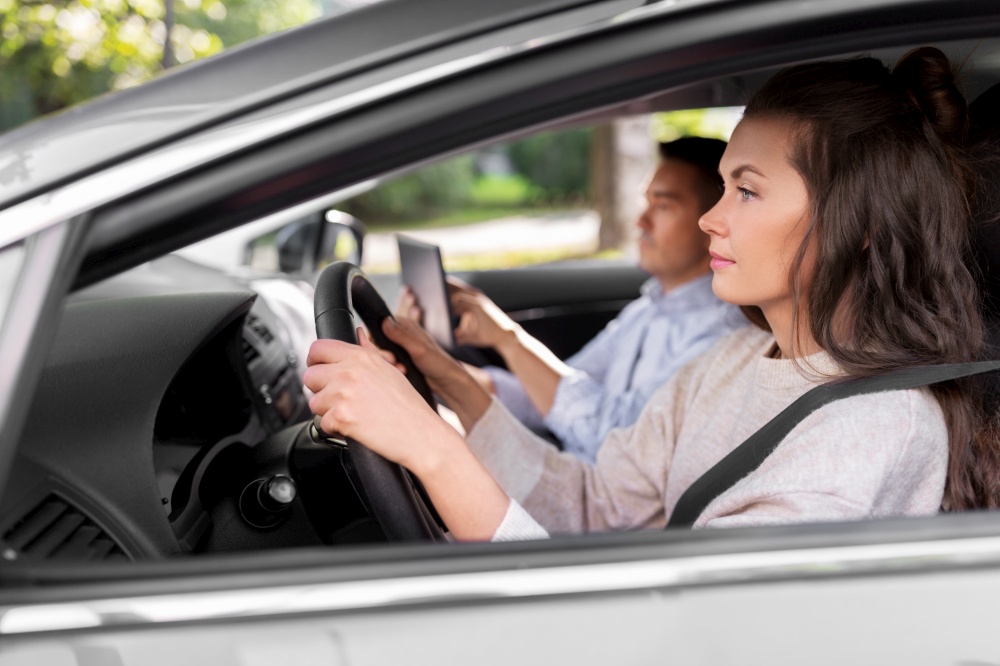 driver courses and people concept - car driving school instructor teaching young woman to drive. car driving school instructor teaching woman