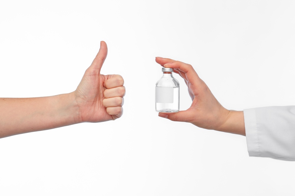 medicine, vaccination and healthcare concept - hand of doctor with drug in bottle and patient showing thumbs up over white background. hand with medicine and showing thumbs up