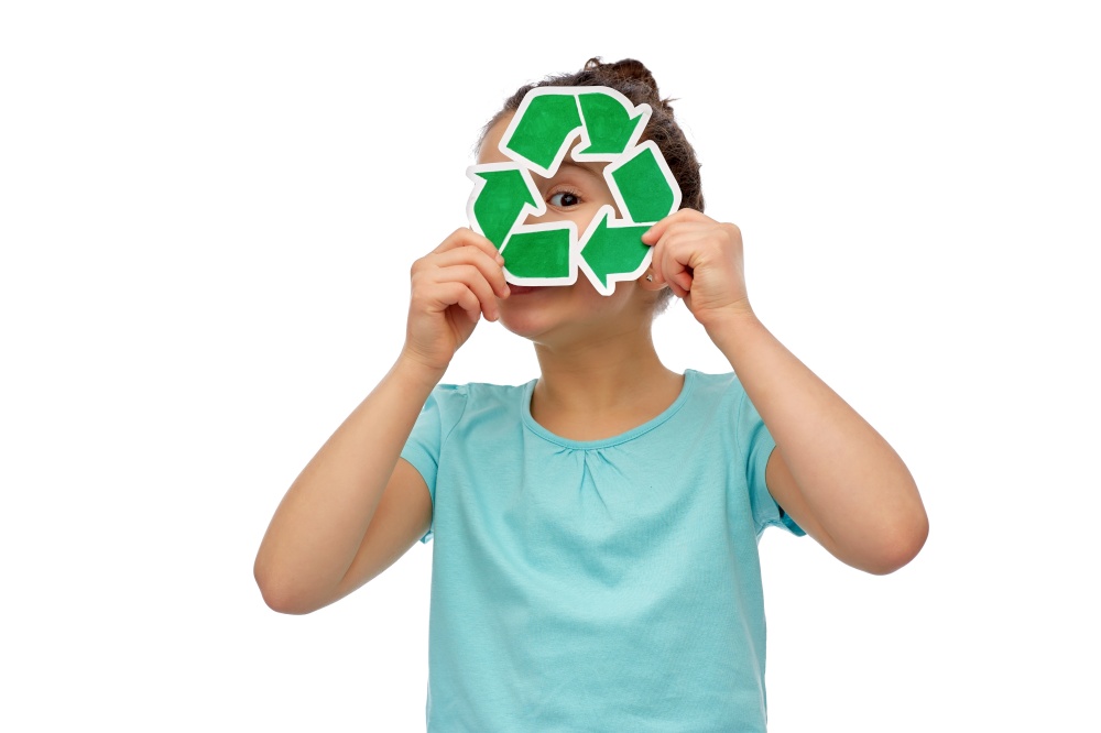 eco living, environment and sustainability concept - little curious girl looking through green recycling sign over white background. curious girl looking through green recycling sign