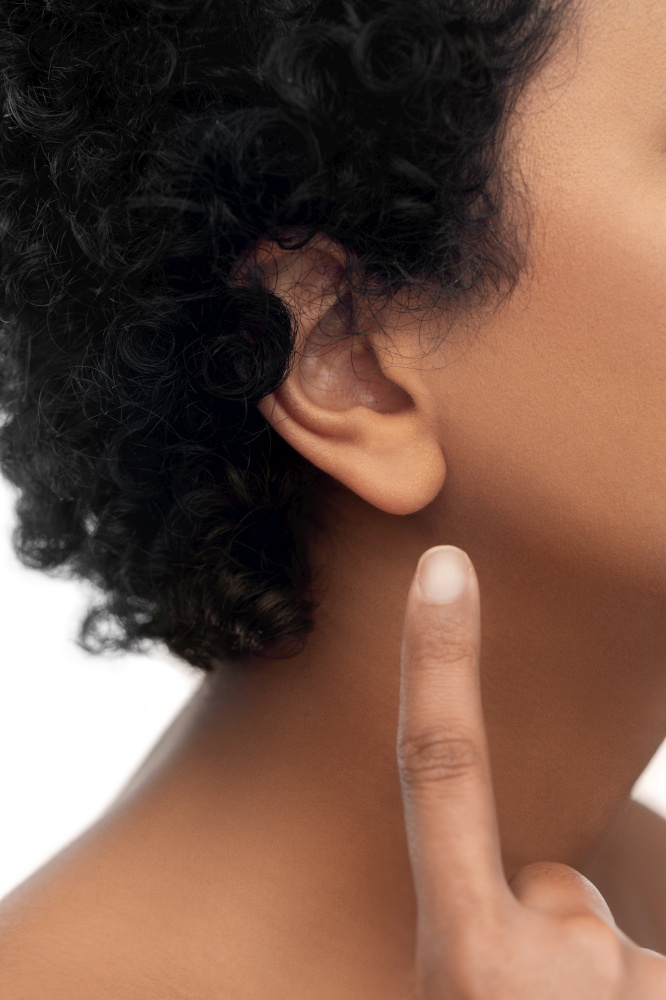 hearing, health and beauty concept - close up of african american woman&rsquo;s ear over white background. close up of african american woman&rsquo;s ear