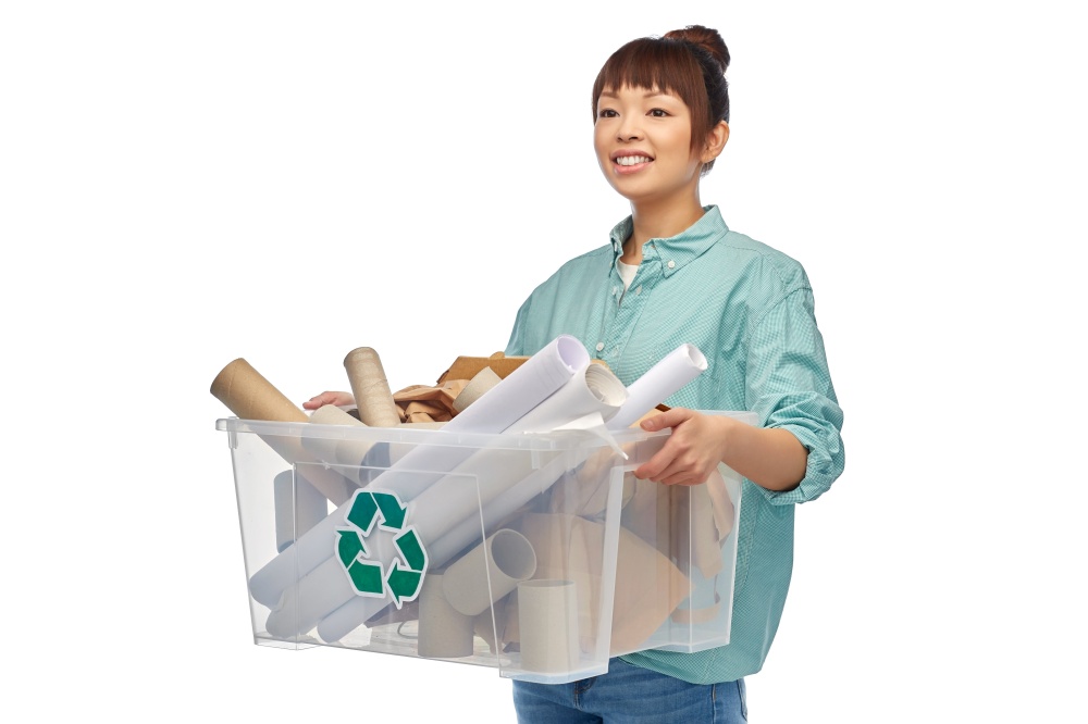 recycling, waste sorting and sustainability concept - happy smiling young asian woman holding paper garbage in plastic box over white background. happy smiling asian woman sorting paper waste