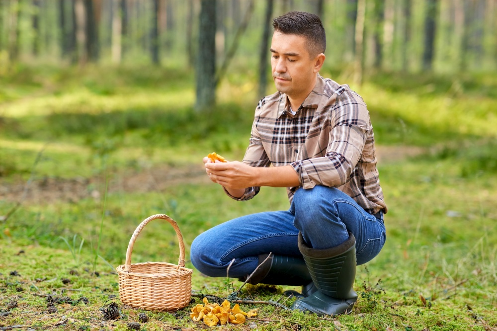 picking season and leisure people concept - middle aged man with wicker basket and mushrooms in autumn forest. man with basket picking mushrooms in forest