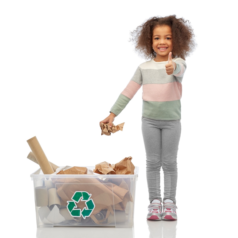 recycling, waste sorting and sustainability concept - smiling african american girl with paper garbage in plastic box showing thumbs up over white background. smiling african american girl sorting paper waste