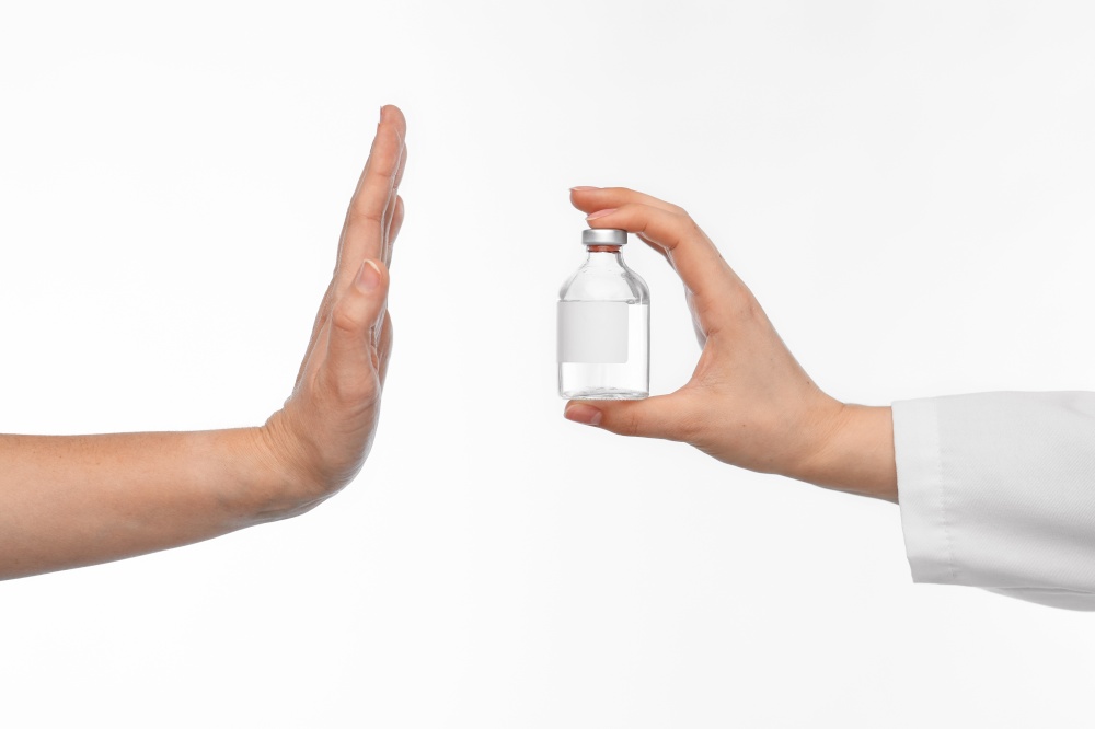 medicine, vaccination and healthcare concept - hand of doctor with drug in bottle and patient showing stop gesture over white background. hand with medicine and showing stop gesture