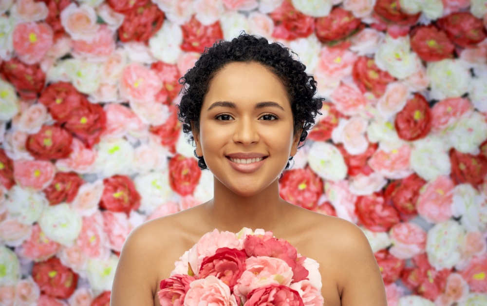 beauty and people concept - portrait of happy smiling young african american woman with flowers over floral background. portrait of african american woman with flowers