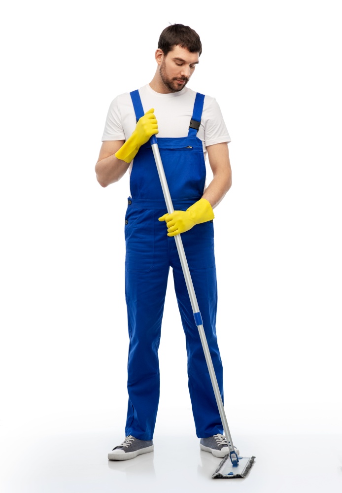profession, service and people - male worker or cleaner in overal and gloves cleaning floor with mop over white background. male cleaner in overal cleaning floor with mop