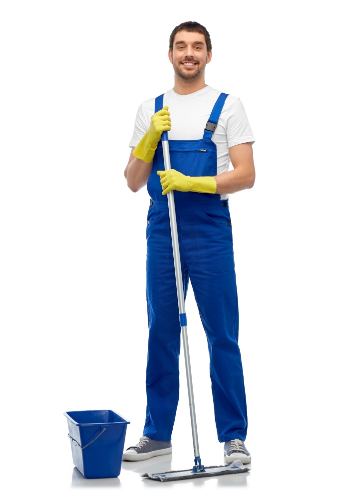 profession, service and people concept - happy smiling male worker or cleaner in overall and gloves cleaning floor with mop and bucket over white background. male cleaner cleaning floor with mop and bucket