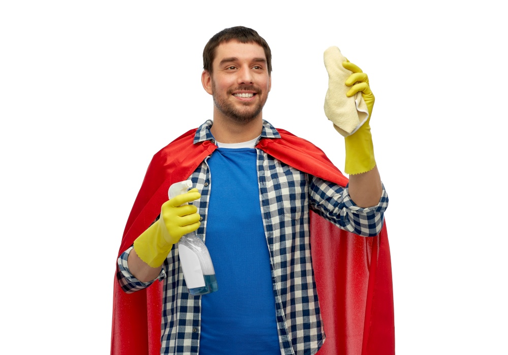 cleaning and people concept - happy smiling man in superhero cape and rubber gloves with rag and detergent over white background. smiling man in superhero cape with rag and cleaner