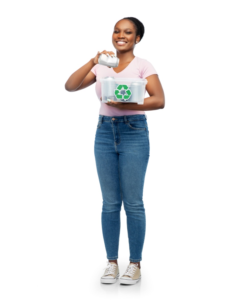 metal recycling, waste sorting and sustainability concept - happy african american woman holding plastic box with tin cans over white background. african american woman sorting metallic waste