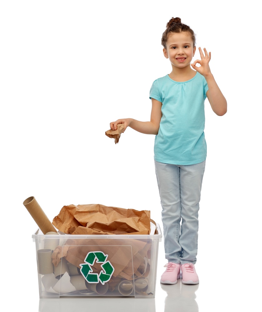 recycling, waste sorting and sustainability concept - smiling girl with paper garbage in plastic box showing ok hand sign over white background. smiling girl sorting paper waste