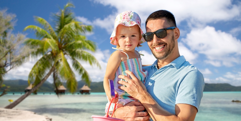 family, fatherhood and travel concept - happy smiling father with little daughter over tropical beach background in french polynesia. happy father with little daughter on beach