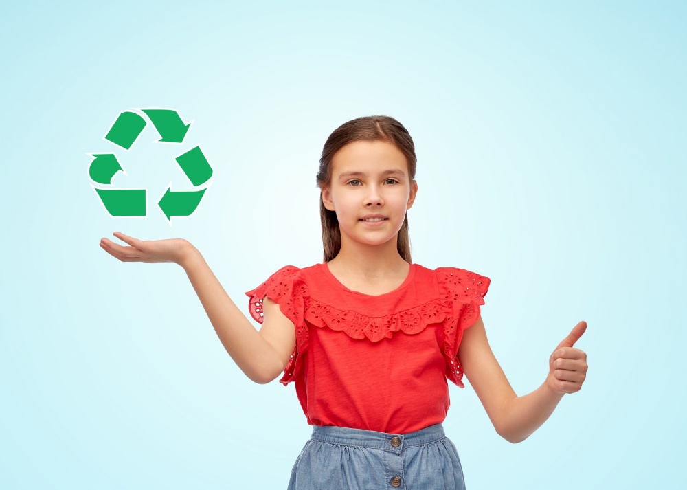 people, children and gesture concept - happy smiling girl showing thumbs up and holding green recycling sign over blue background. girl showing thumbs up and holding recycling sign