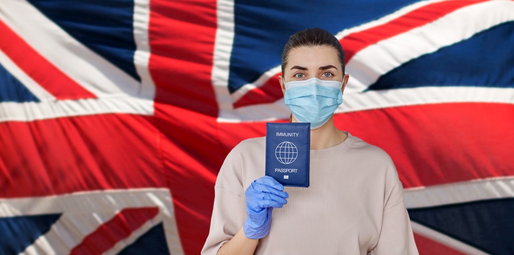 health protection, vaccination and pandemic concept - close up of young woman in medical mask and gloves holding immunity passport over flag of united kingdom on background. woman in mask and gloves holding immunity passport