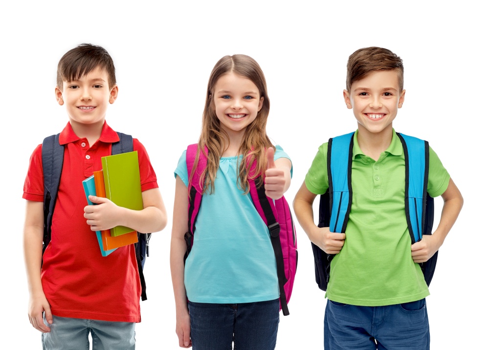 education, learning and people concept - group of happy smiling children with school bags showing thumbs up over white background. happy children with school bags showing thumbs up